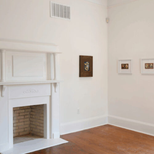 Preternatural exhibition hanging on walls next to fireplace in Spruill Gallery
